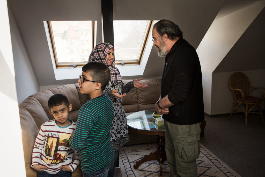 International Rescue Committee ambassador, and actor, Mandy Patinkin, reconnects with a Syrian refugee family.